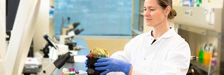 Researcher using a centrifuge