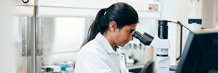 Scientist at microscope